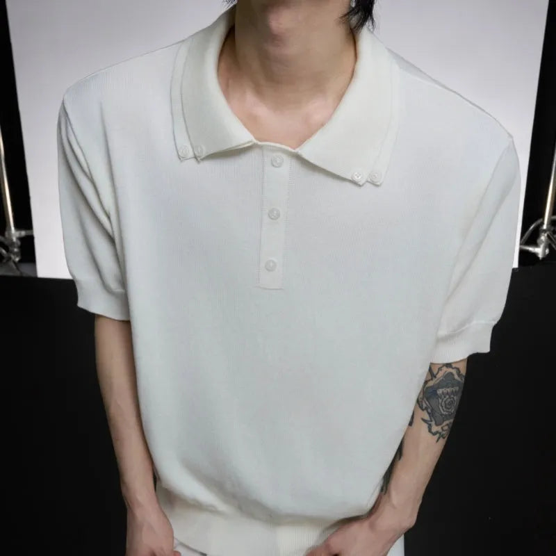 Man wearing a black loose-fit short sleeve shirt with a double lapel collar