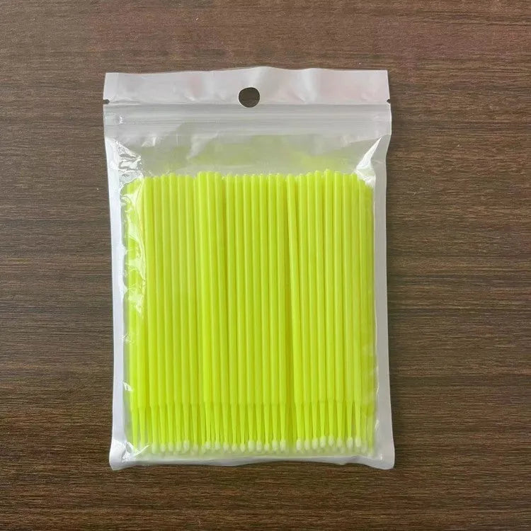 Disposable micro applicator brushes with bendable cotton tips and colour-coded handles for eyelash extensions