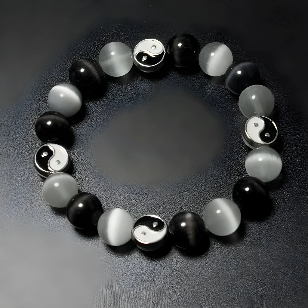 Close-up of a natural opal Tai Chi beaded bracelet with 10mm polished stones on a wrist.