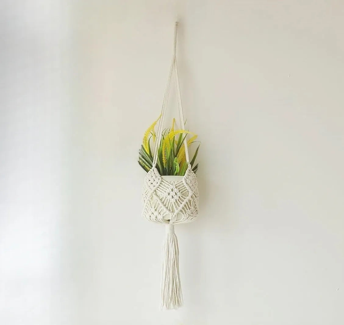 Hand-woven brown polyester cotton net pocket extension cord on a grey flower pot.