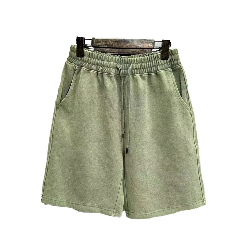 Men's navy blue cotton shorts with a distressed design and loose straight-leg fit on a mannequin.