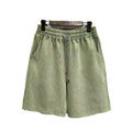 Men's navy blue cotton shorts with a distressed design and loose straight-leg fit on a mannequin.