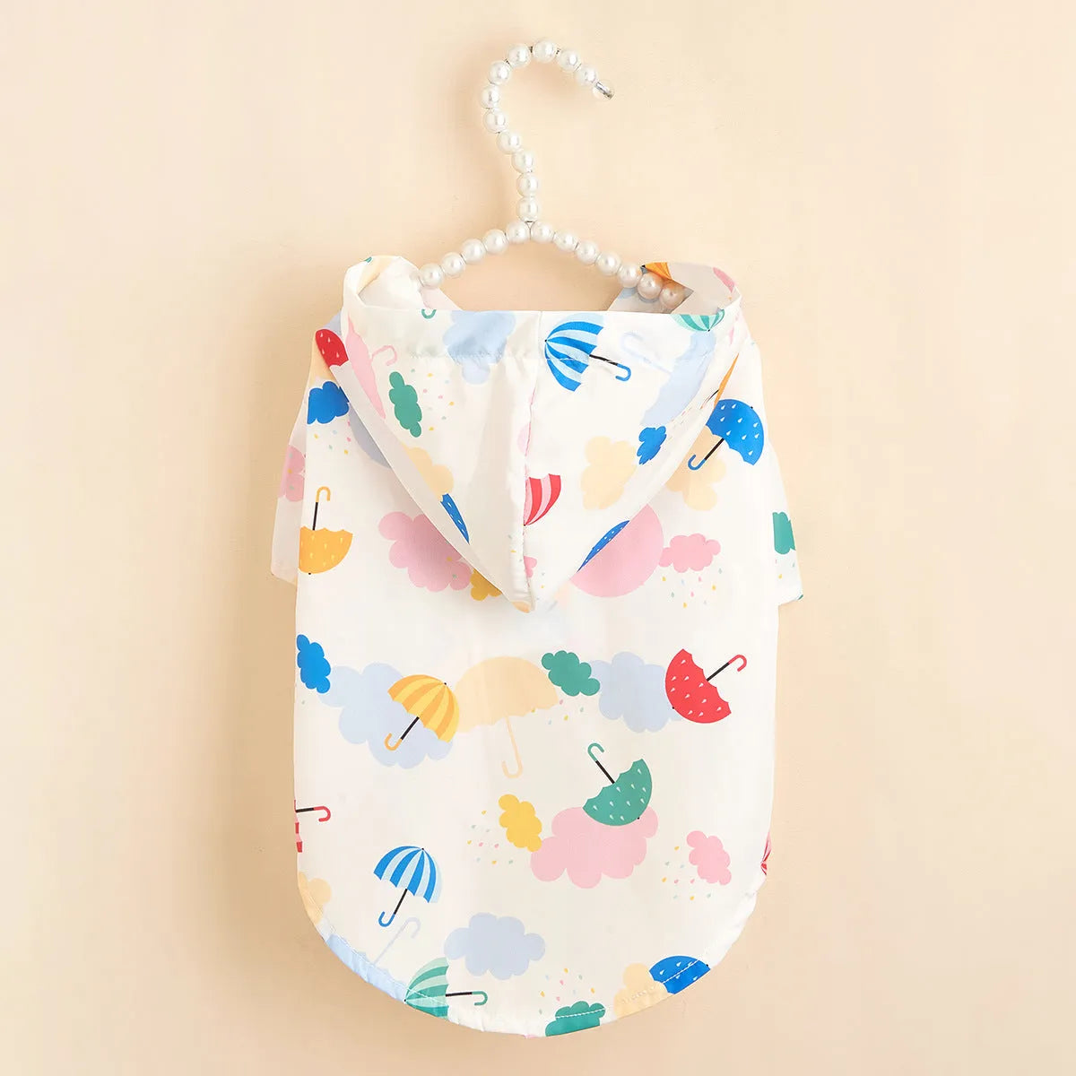 Colourful cartoon umbrella pattern dog raincoat in size L on a mannequin.