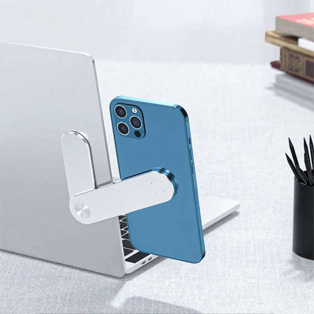Black aluminium magnetic phone holder clipped to the side of a silver laptop.