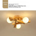 Wooden style living room ceiling light with three adjustable heads in Nordic modern design
