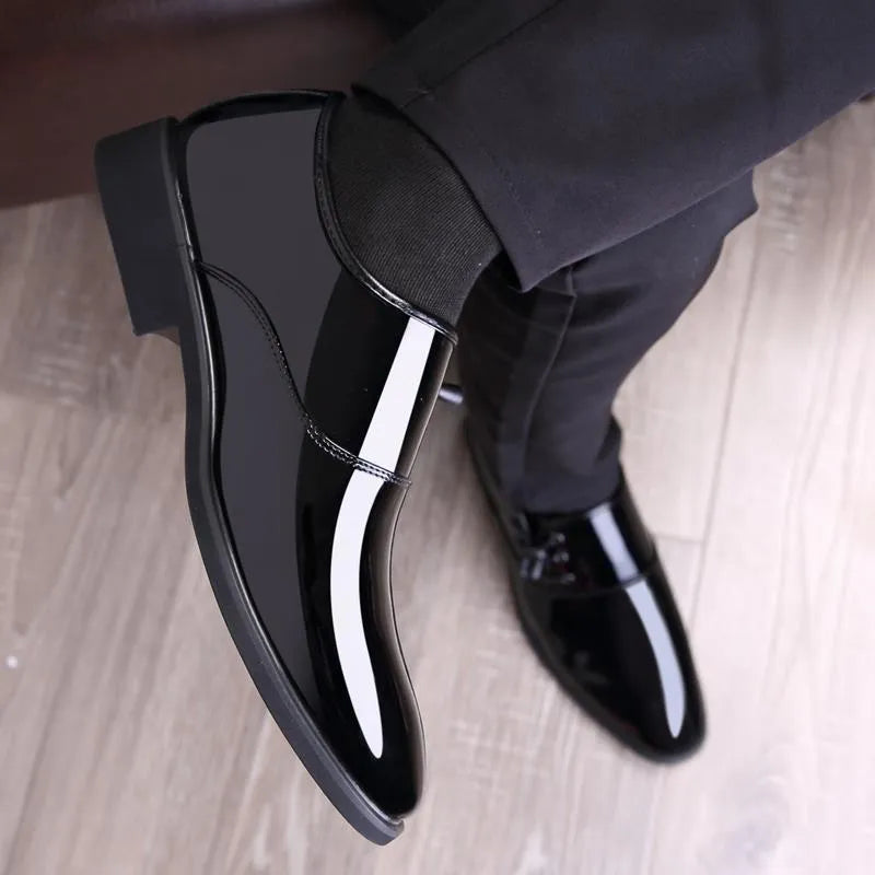Men's black and brown formal oversleeve shoes with round toe and square heel on a rubber sole.
