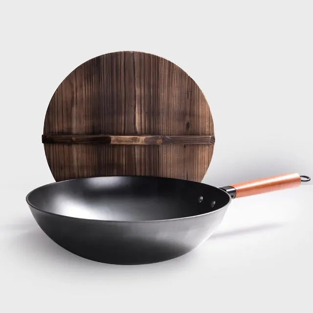 Traditional black iron wok with wooden handle measuring 32cm in diameter