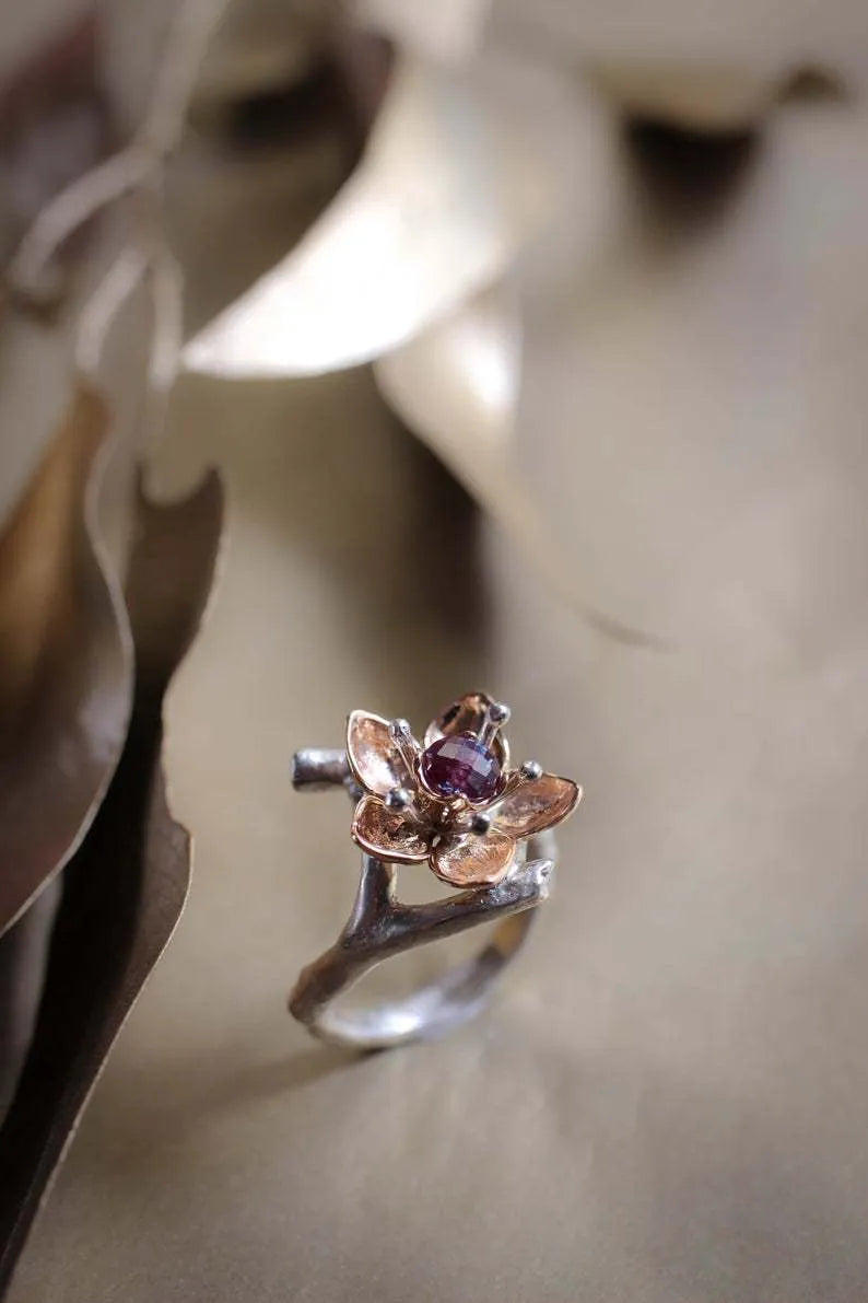 Silver two-tone women's ring with geometric floral design showing alloy construction and size options