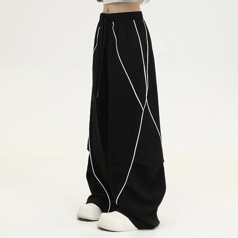 Black pleated wide-leg hip hop pants with striped pattern and mid-waist design made of polyester
