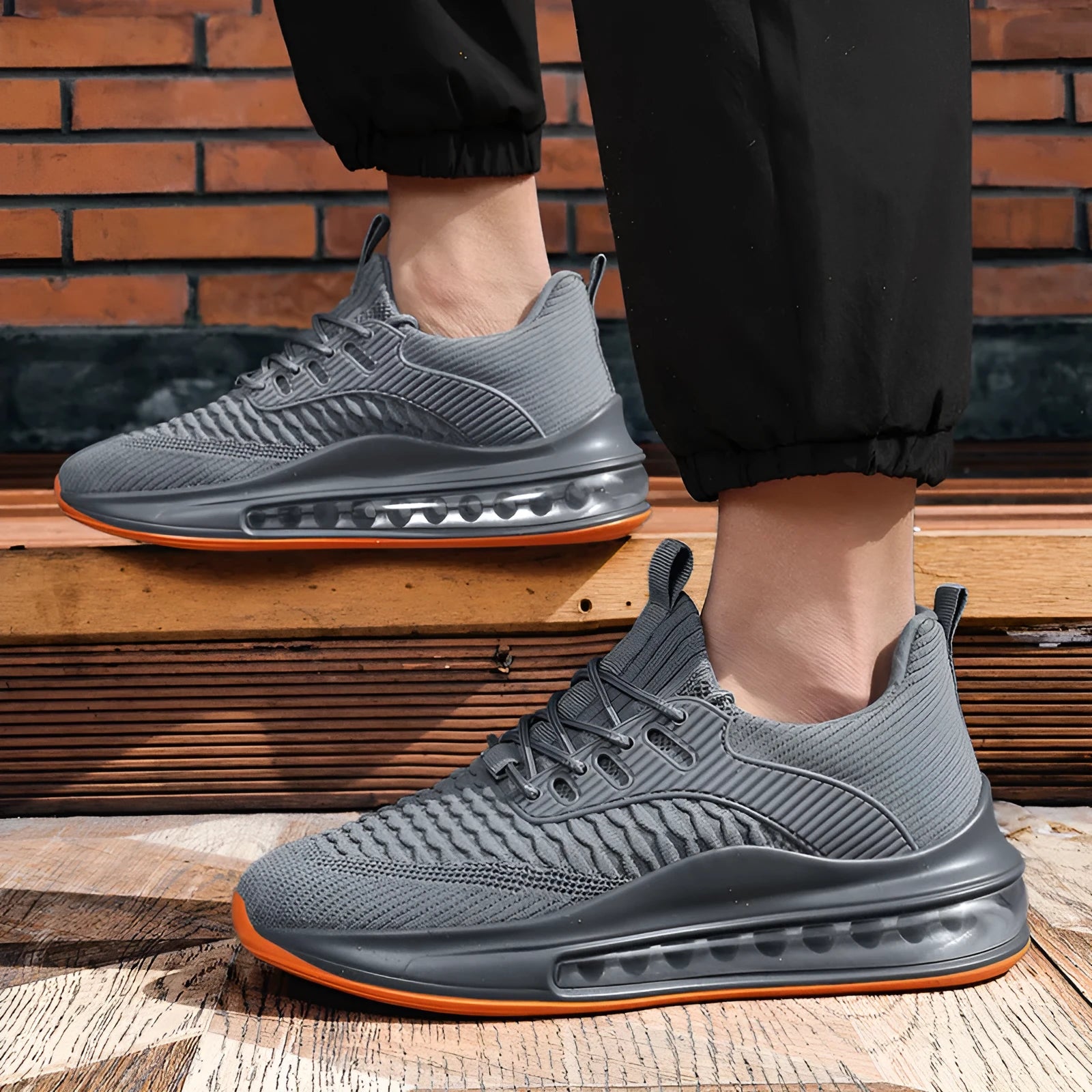 Men's low-top black breathable mesh running sneakers with white rubber sole on a solid background.