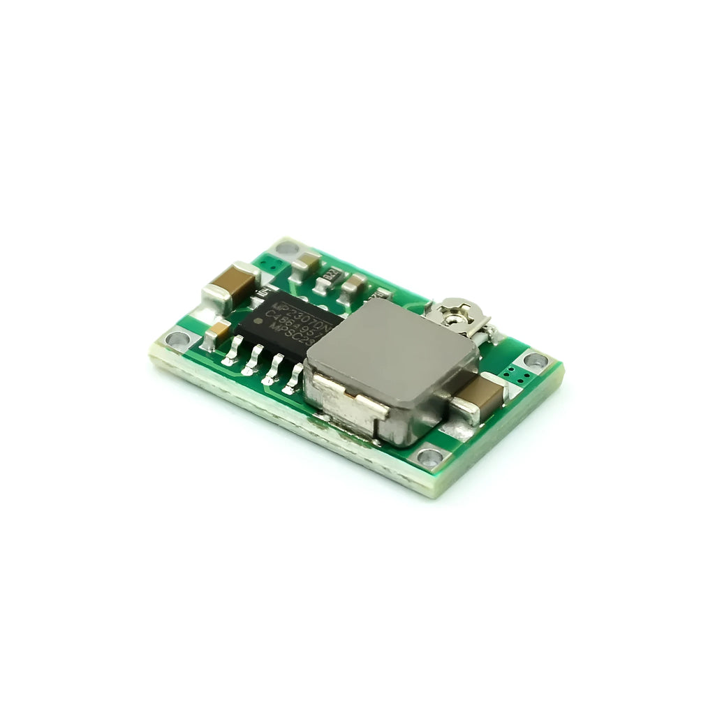 Mini 360 green DC-DC buck converter step down power supply module on white background
