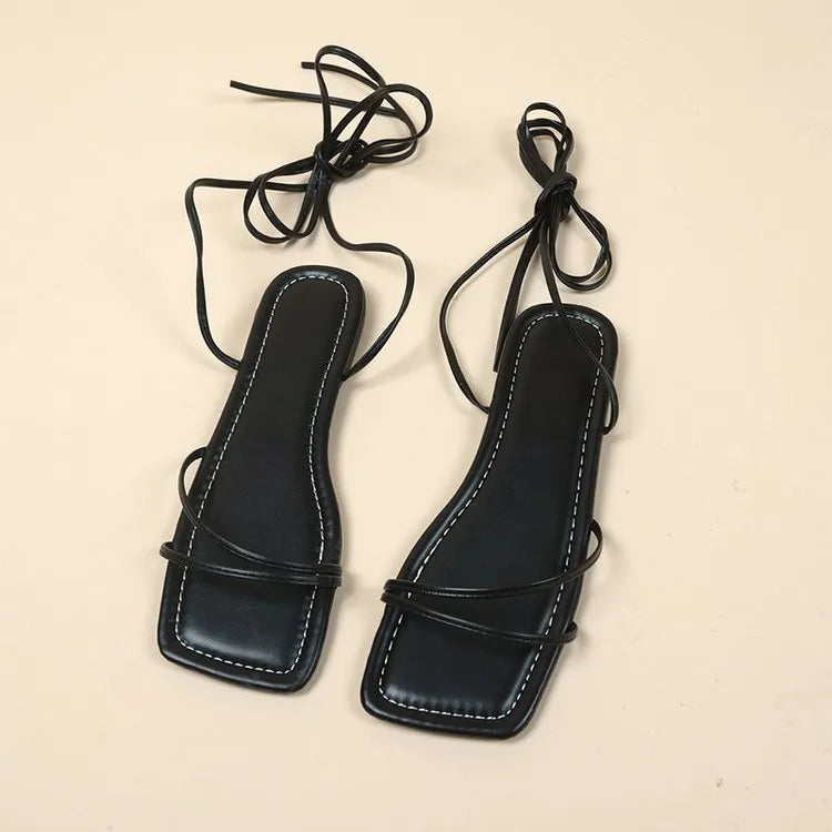 Women's flat sandals with ankle ring bandage detail and front lace-up closure in square-toe design