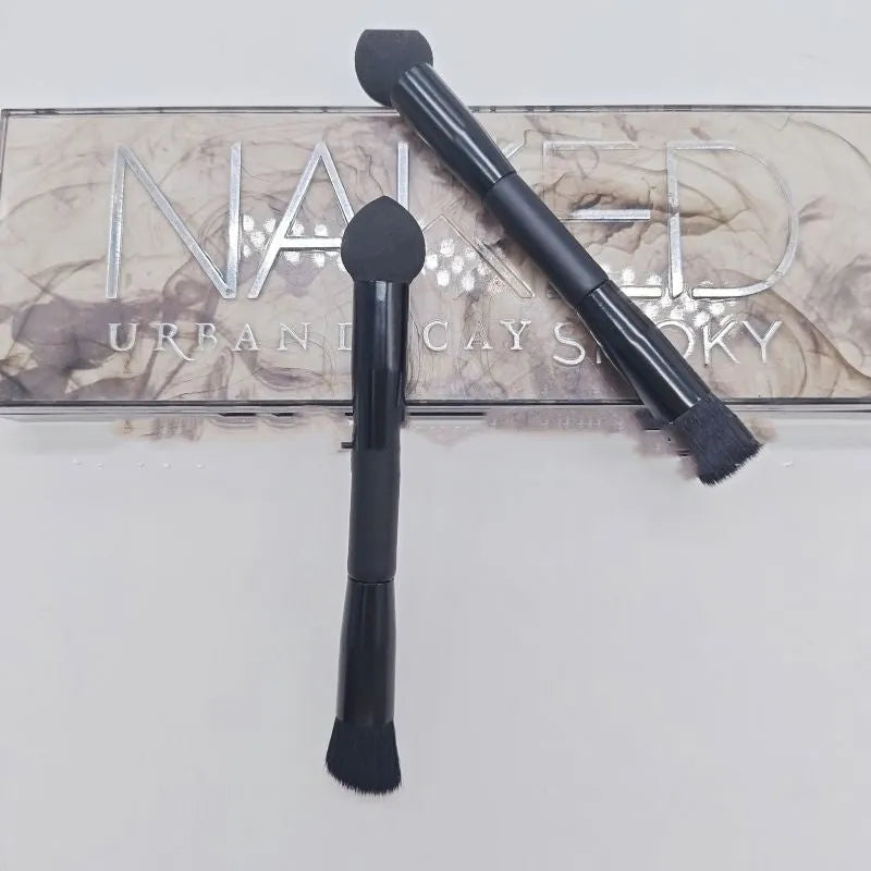 Black foam sponge tip concealer brush with a wooden handle for under-eye makeup application.