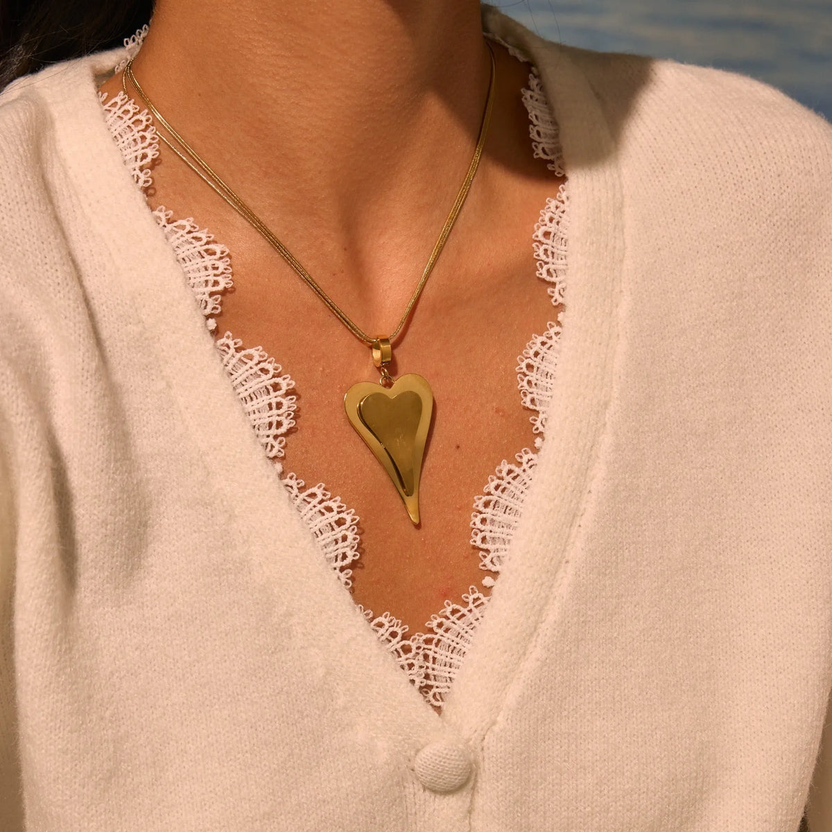 Women's stainless steel necklace with double heart geometric pendant featuring snake bones design in gold plating