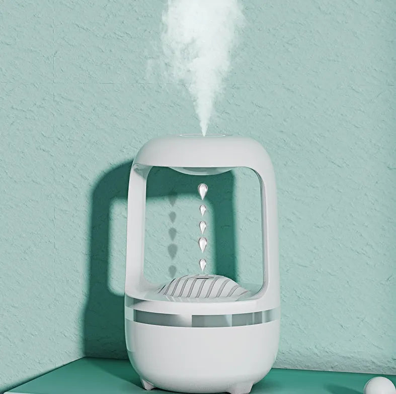 White anti-gravity humidifier showing water droplet backflow effect with USB cable connection