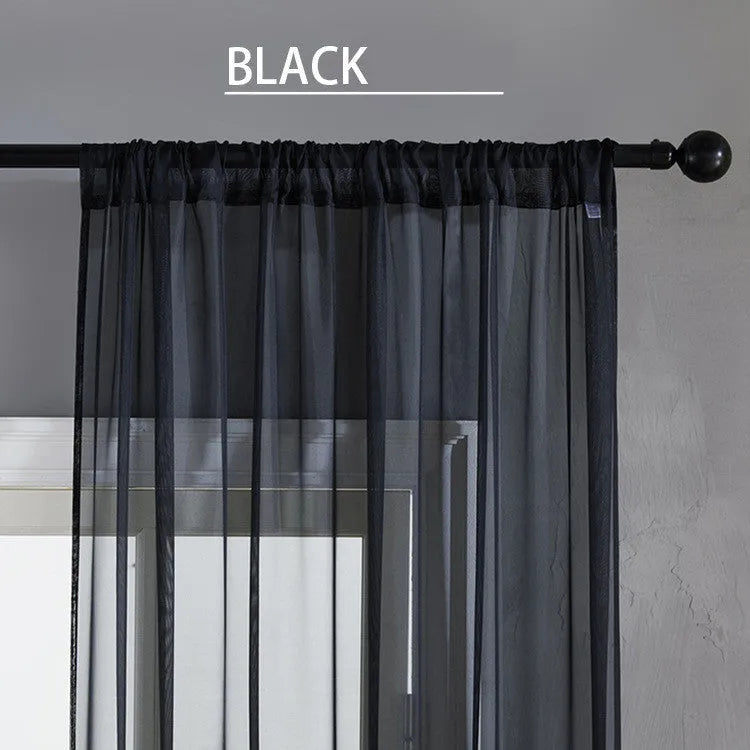 Modern simple black cotton linen vertical perforated curtain hung on a window.
