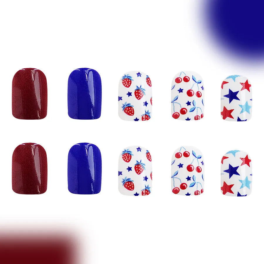 Short glossy press-on nails with strawberry and cherry图案 in red and blue colours