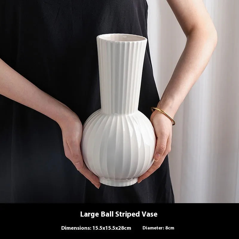 White ceramic ball striped vase in American country style on table with orchid arrangement