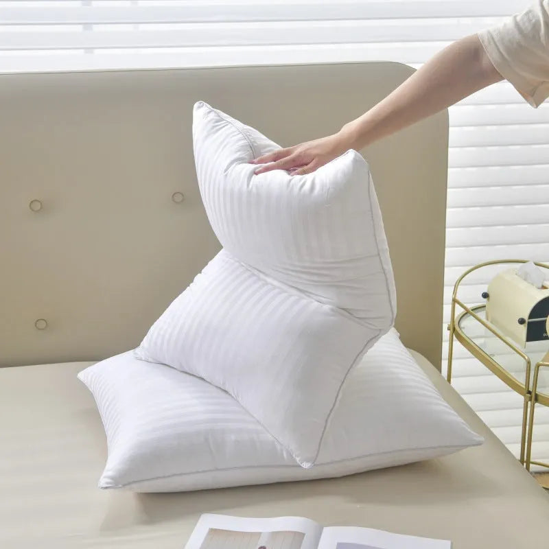 White cotton pillow with satin stripe pattern showing feather and cotton fill in three available sizes