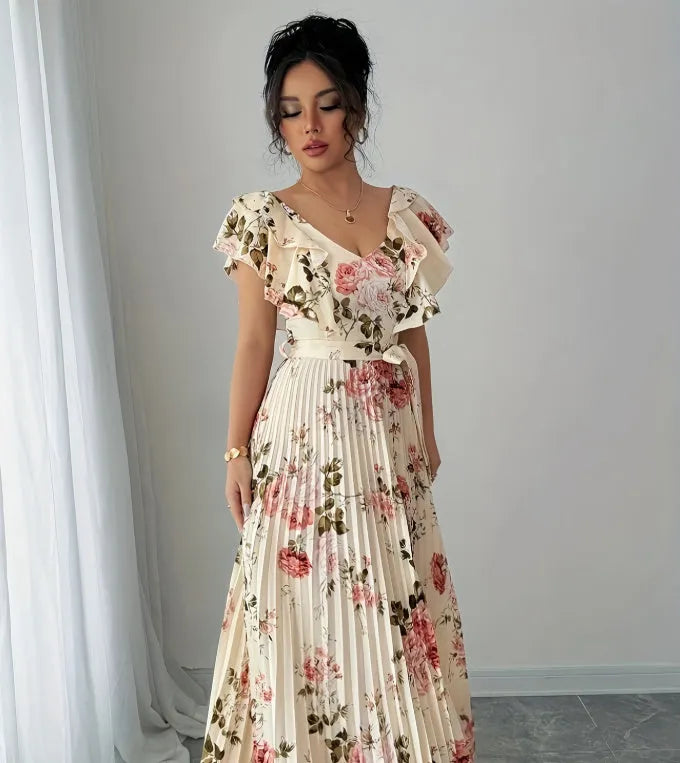 Apricot coloured floral print dress with V-neck, ruffled short sleeves, and a high-waisted oversized swing skirt.