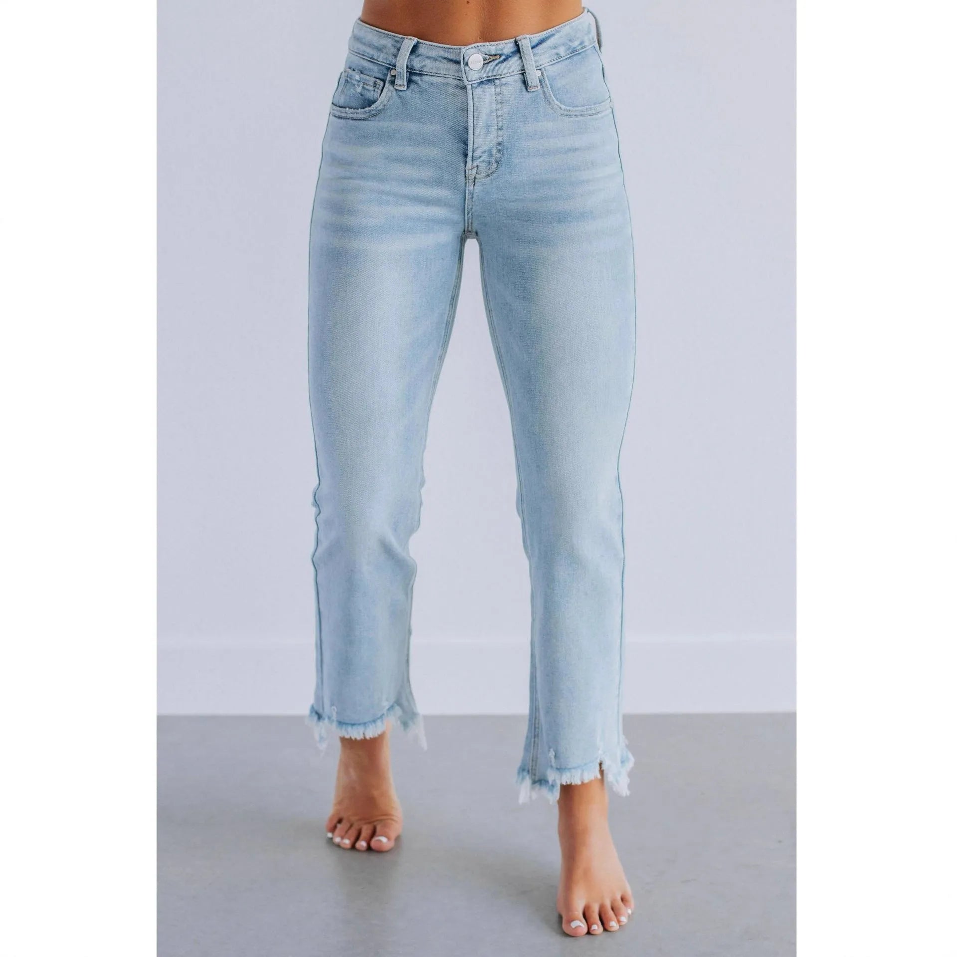 Women's solid colour denim jeans with hand-worn distressing in light blue wash, straight leg fit