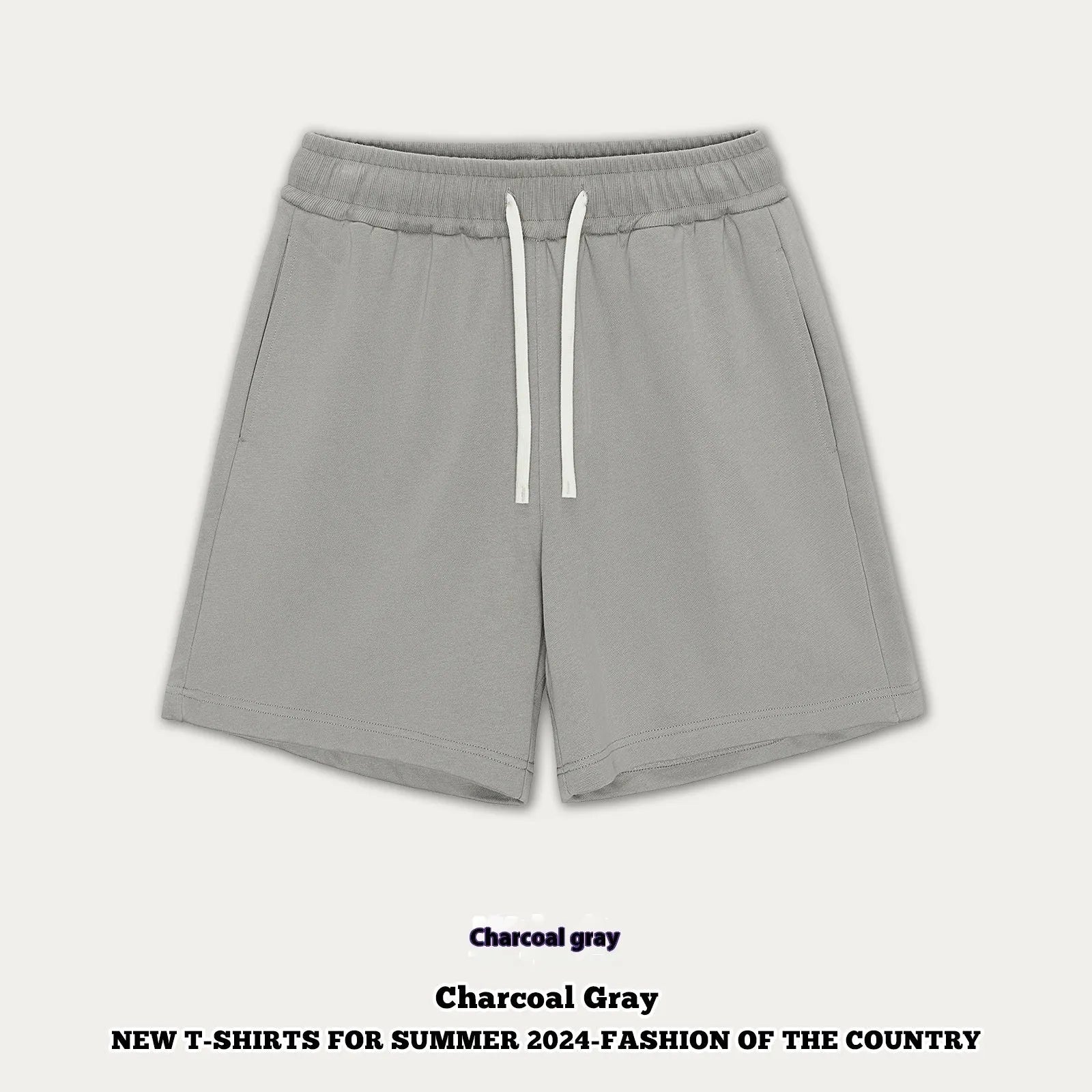 Baby boy and girl wearing loose-fit cotton denim shorts in charcoal grey and cream apricot colours.