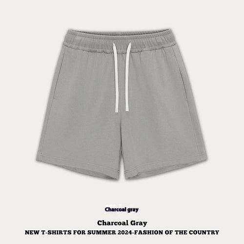Baby boy and girl wearing loose-fit cotton denim shorts in charcoal grey and cream apricot colours.