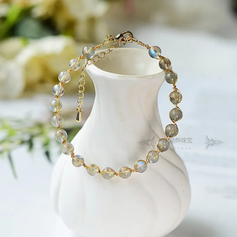 Women's bracelet with blue moonstone beads and gold-gilded metal in a starry sky design.