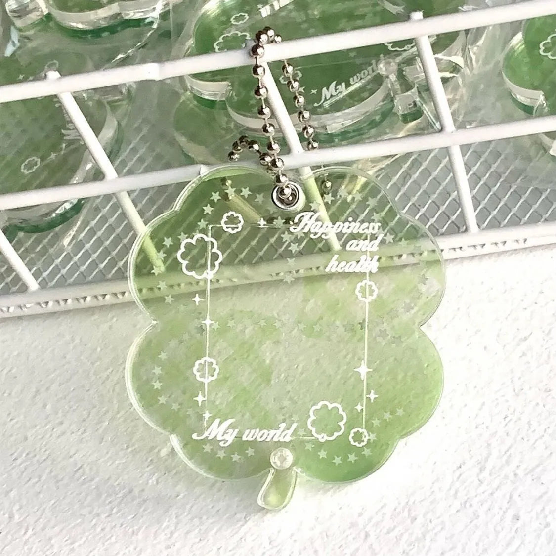 Acrylic four-leaf clover pendant keychain in elegant blue, grass green, and mint green colours.