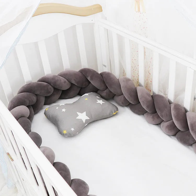Braided knot design baby crib bumper in spandex velvet, shown in a light grey colour.