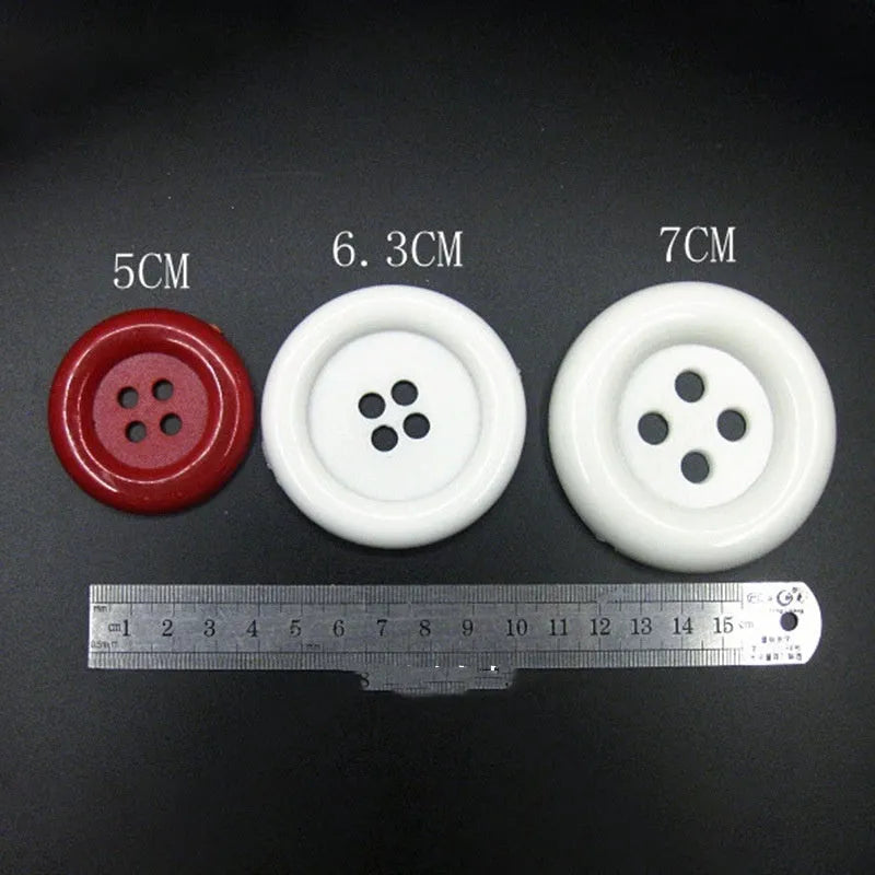 Assortment of oversized round plastic buttons in multiple colours showing four-hole design.