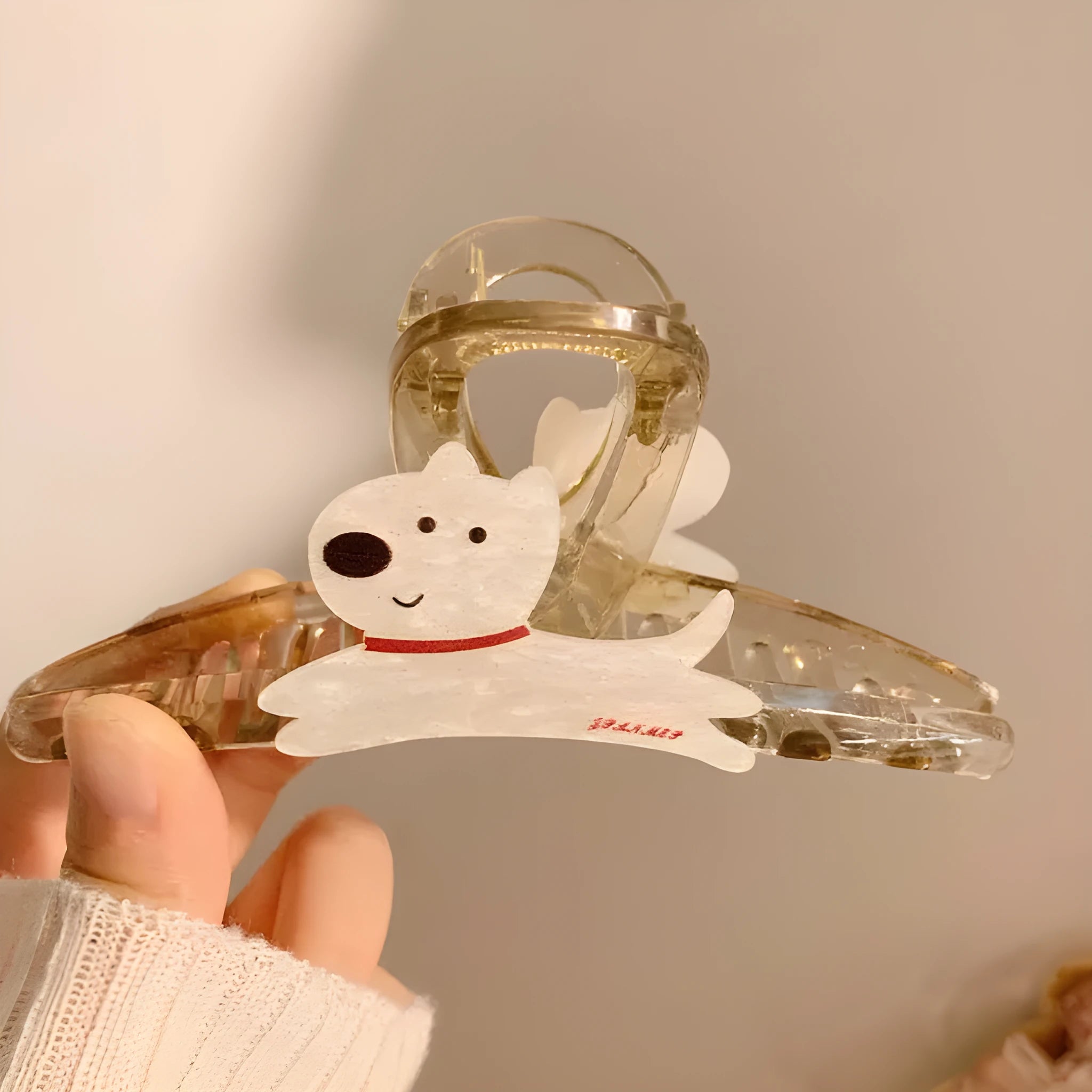 Beige and brown cartoon puppy hair grip barrettes on white background