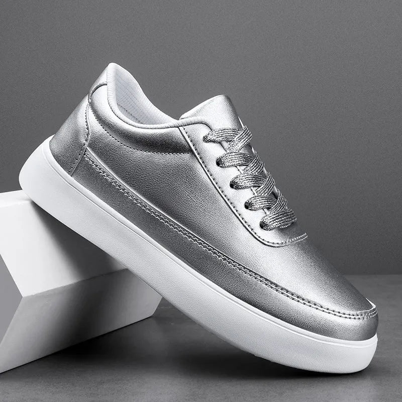 Women's white leather flat lace-up shoes on a solid background.
