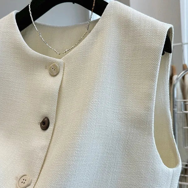 Sleeveless bandage dress vest with round neck in milky white or black polyester fabric.