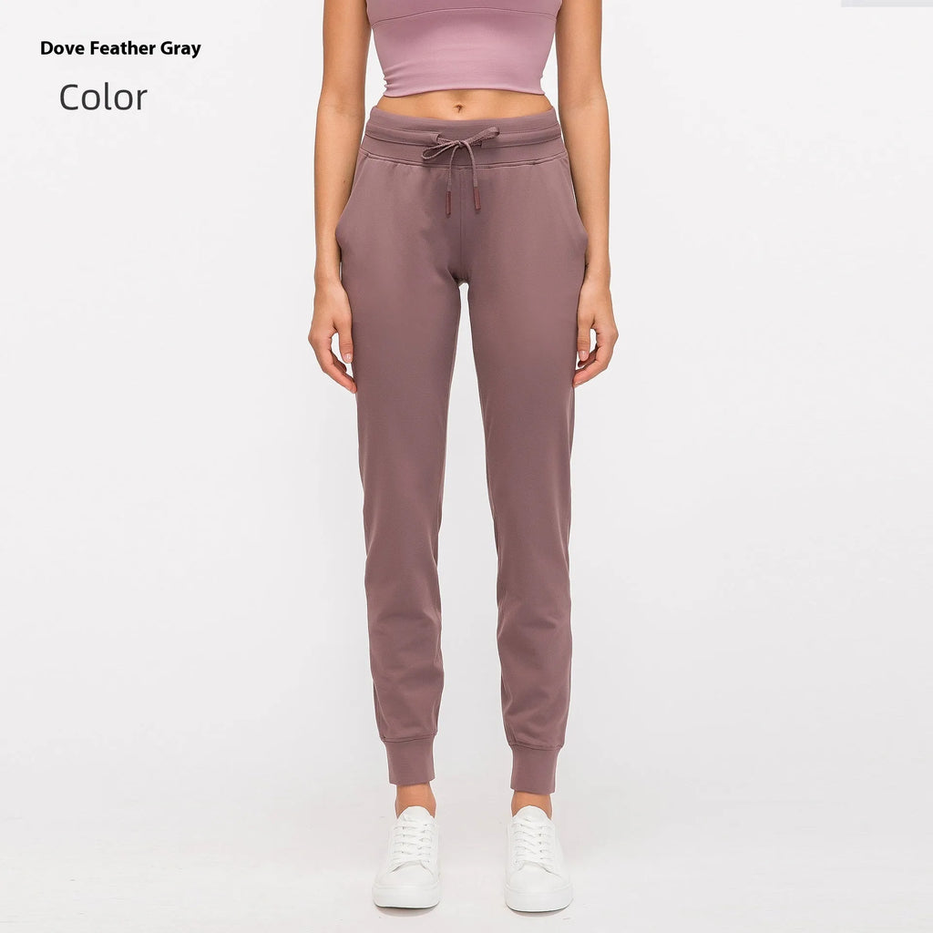 Women's high waist yoga pants with drawstring in navy blue, laid flat to show fit and fabric detail.