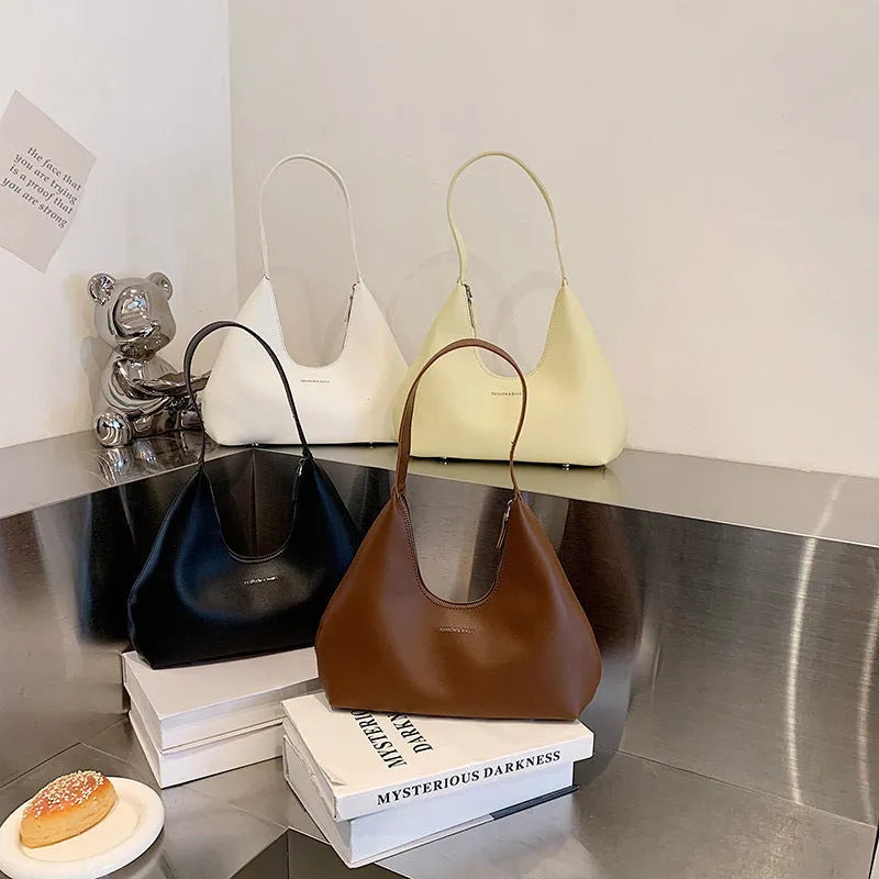Retro style PU shoulder handbag in pillow shape with single strap and internal organisation pockets