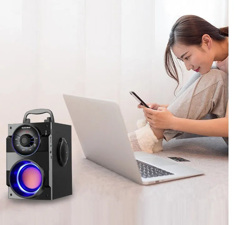 Black portable mini home audio system with subwoofer, satellite speakers, and a 3.5mm audio cable