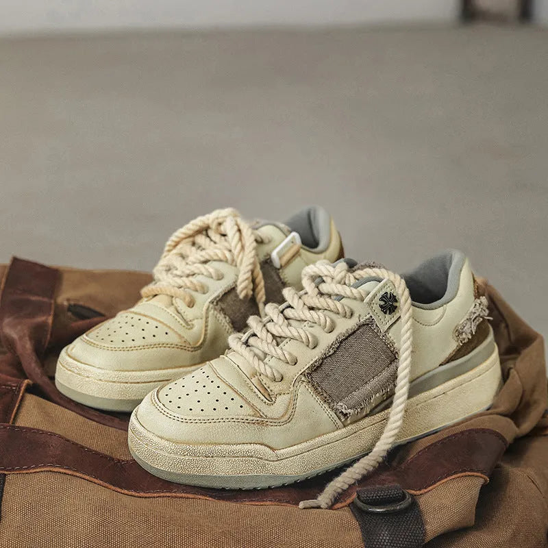Beige low-top vintage style skate shoes with lace-up front and rubber sole.