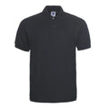 A plus size model wearing a solid colour short sleeve polo shirt with a lapel collar.