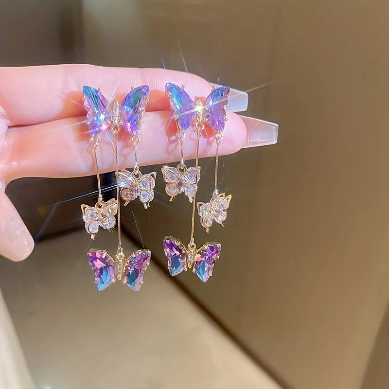 Blue purple butterfly tassel earrings with silver crystal flowers on alloy settings.