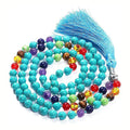Long beaded agate necklace with geometric stones and a tassel, showing colourful variations.