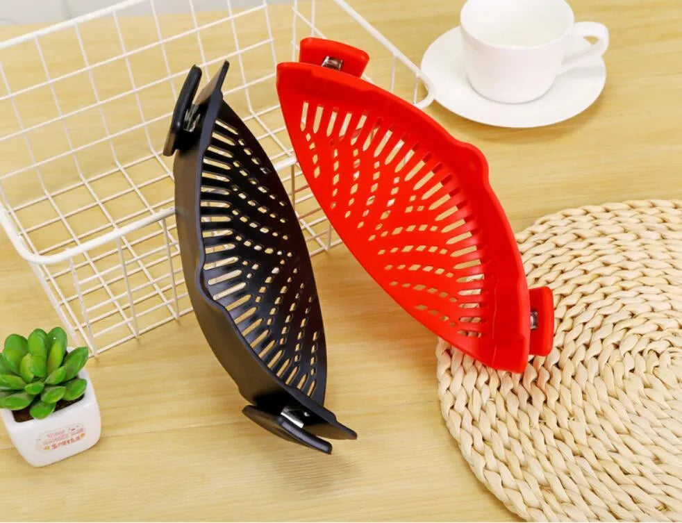 Silicone clip-on funnel strainer attached to kitchen pot for draining liquids