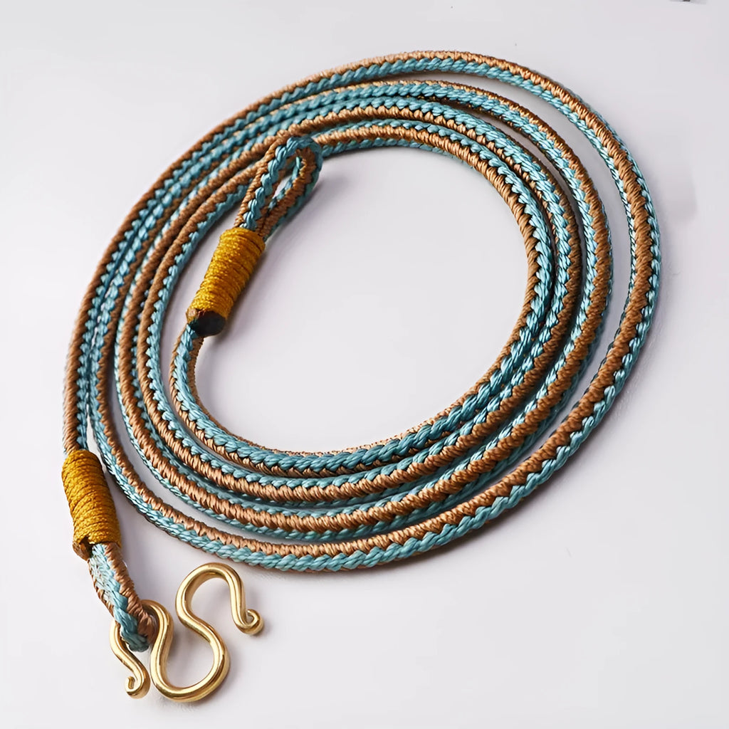 Gold Tibetan Thangka peace buckle necklace with gem inlays on an imitation pearl perimeter.