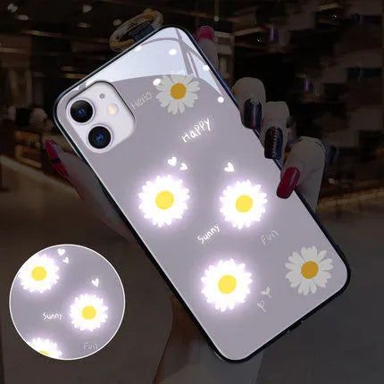 White daisy design luminous iPhone case with voice-activated colour light on a mobile phone.