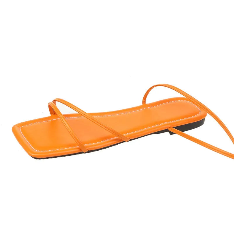 Women's flat sandals with ankle ring bandage detail and front lace-up closure in square-toe design