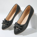 Women's beige casual flat slip-on shoes with a bowknot and shallow mouth design on a rubber sole.