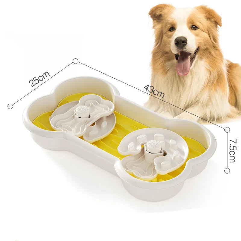 Large green slow feeder dog bowl with wave-pattern trays and suction cups on a wooden floor.