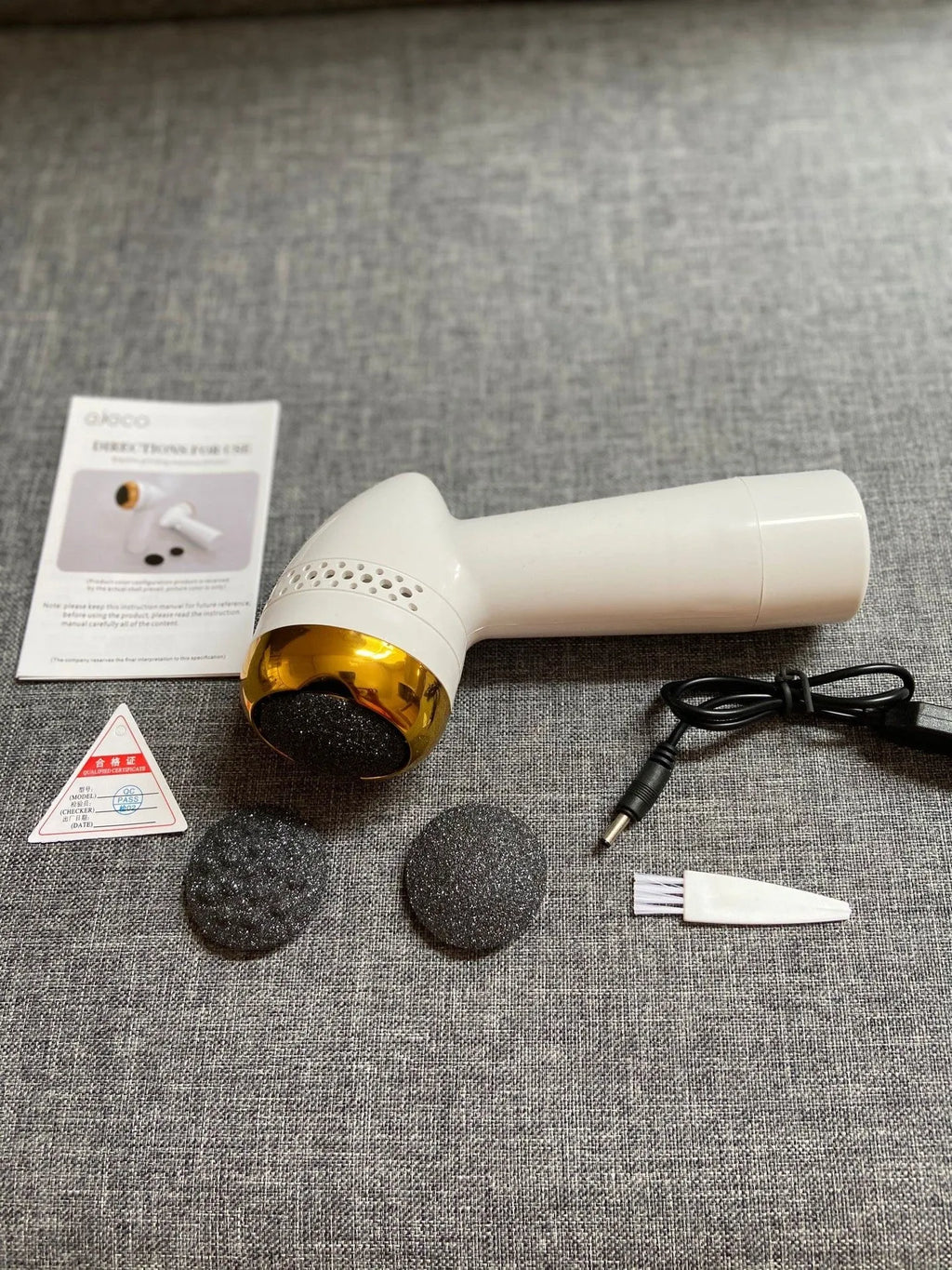 Electric vacuum foot grinder in metallic gold finish with a refined quartz grinding head.