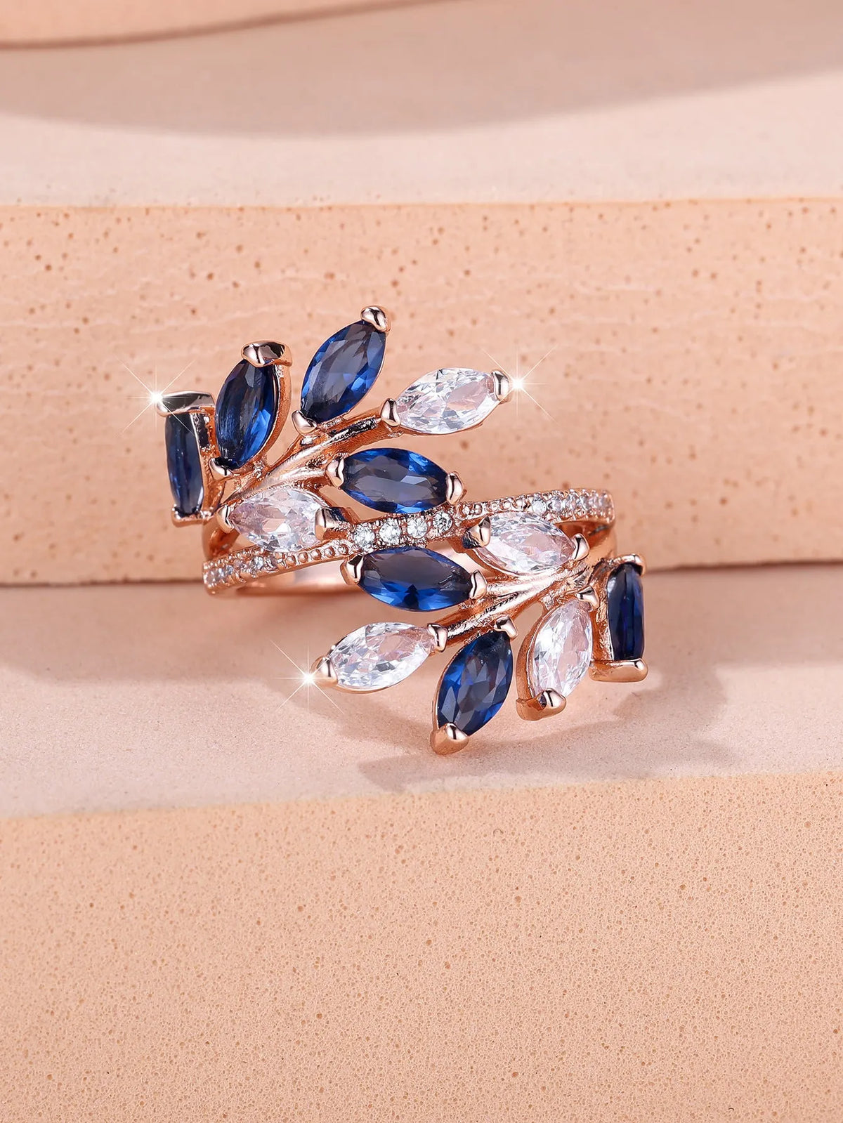 Adjustable horse eye zircon leaf ring in rose gold or platinum plating on a model's hand.