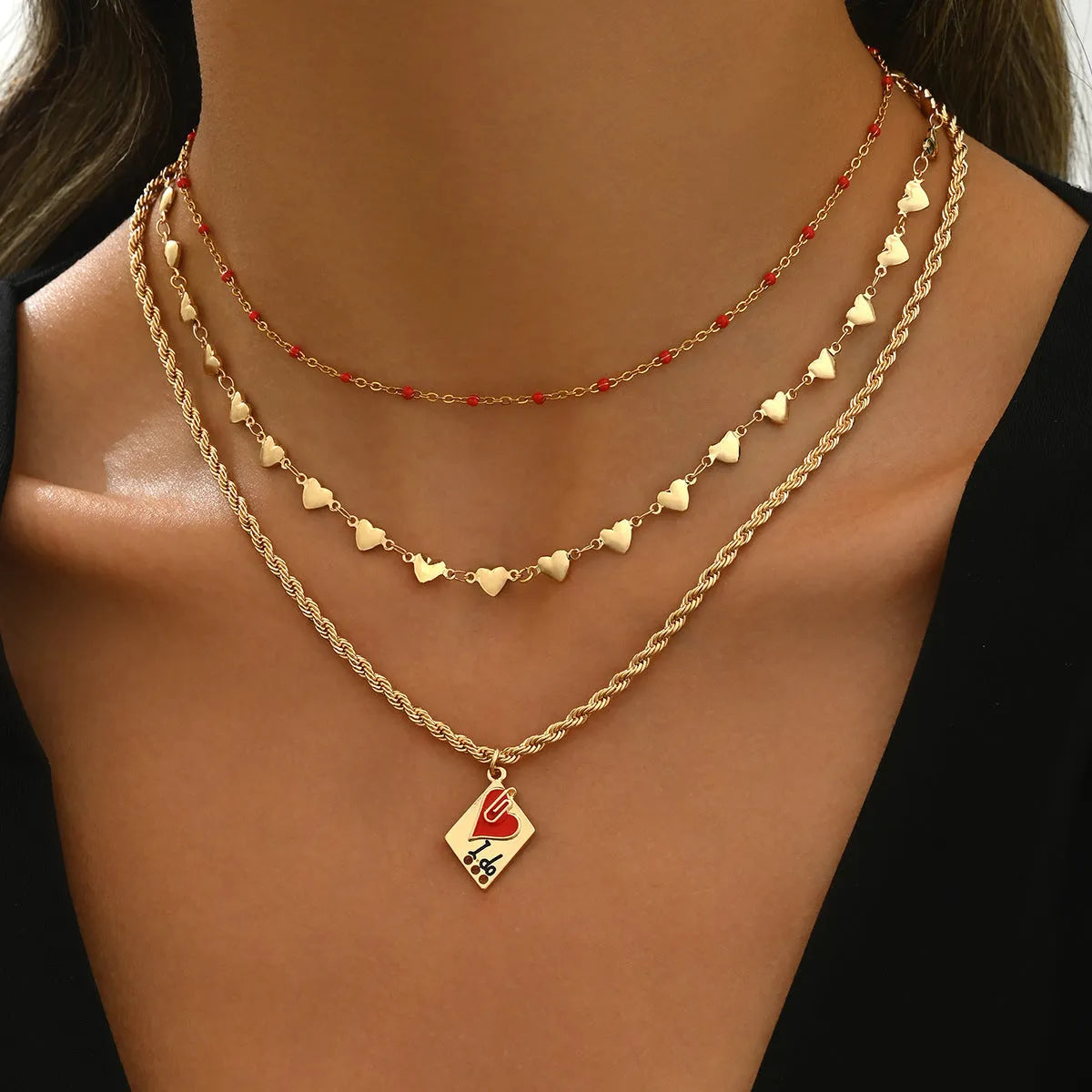 Golden three-layer adjustable clavicle chain necklace with geometric heart pendant